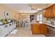 Open floor plan showcasing dining area with wooden cabinets and table with chairs and tiled floor at 1002 Corey Ln, Plainfield, IN 46168