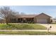 Charming single-story brick home with attached garage, mature trees, and manicured lawn at 1002 Corey Ln, Plainfield, IN 46168