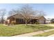 A charming, single story brick home featuring an attached garage, lawn, and mature trees at 1002 Corey Ln, Plainfield, IN 46168