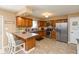A spacious kitchen featuring warm wood cabinets, stainless steel appliances, and tiled flooring at 1002 Corey Ln, Plainfield, IN 46168