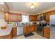 Functional kitchen design showcasing stainless steel appliances and rich wood cabinets at 1002 Corey Ln, Plainfield, IN 46168