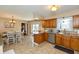 Open kitchen with wood cabinetry, stainless appliances and sight lines to the dining room at 1002 Corey Ln, Plainfield, IN 46168