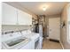 Bright laundry room featuring a modern washer and dryer set, white cabinetry, and neutral walls at 1002 Corey Ln, Plainfield, IN 46168