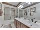 A traditional bathroom features neutral walls, double sinks, and a shower with glass doors at 1021 Hudson Bay Dr, Greenwood, IN 46142