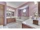 Spacious bathroom has dual sinks, a soaking tub and a unique stained-glass window at 1021 Hudson Bay Dr, Greenwood, IN 46142