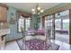 Charming dining area with a glass table, elegant chairs, and a sliding glass door leading to the outdoor patio at 1021 Hudson Bay Dr, Greenwood, IN 46142