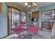 Stylish dining area featuring a glass-top table, chandelier, and seamless access to the outdoor patio, ideal for entertaining at 1021 Hudson Bay Dr, Greenwood, IN 46142