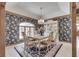 Elegant dining room with dark floral wallpaper, a stylish chandelier, and ample seating at 1021 Hudson Bay Dr, Greenwood, IN 46142