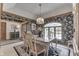 Formal dining room featuring dark floral wallpaper, decorative trim, and abundant natural light at 1021 Hudson Bay Dr, Greenwood, IN 46142