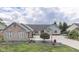 Inviting brick home with an expansive driveway and manicured landscaping at 1021 Hudson Bay Dr, Greenwood, IN 46142