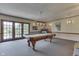 Spacious game room features a classic billiard table and adjacent outdoor access at 1021 Hudson Bay Dr, Greenwood, IN 46142