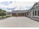 A three-car garage is accessible via a concrete driveway adjacent to the brick home at 1021 Hudson Bay Dr, Greenwood, IN 46142