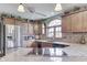 Well-lit kitchen with wood cabinets, granite countertops, stainless steel appliances, and a unique arched window at 1021 Hudson Bay Dr, Greenwood, IN 46142