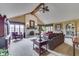 Bright living room boasts a soaring ceiling, a striking brick fireplace, and large windows, creating a warm and inviting atmosphere at 1021 Hudson Bay Dr, Greenwood, IN 46142
