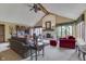 Cozy living room with vaulted ceilings, exposed beams, and a brick fireplace, offers a blend of comfort and elegance at 1021 Hudson Bay Dr, Greenwood, IN 46142