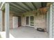 Covered patio with brick wall, storage cabinet, and double doors at 1021 Hudson Bay Dr, Greenwood, IN 46142