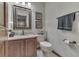 Cozy powder room features wallpaper, framed mirror and granite countertop at 1021 Hudson Bay Dr, Greenwood, IN 46142