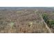 Aerial view of the sprawling property, featuring a picturesque pond and surrounded by verdant trees at 1037 E Woodall Ct, Martinsville, IN 46151