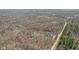 Aerial view showcasing the expansive property, enveloped by lush forest and a tranquil stream at 1037 E Woodall Ct, Martinsville, IN 46151
