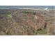 Aerial view of wooded property with a home, pond, and defined property lines in a rural setting at 1037 E Woodall Ct, Martinsville, IN 46151
