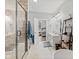 Elegant bathroom featuring double sinks, a walk-in shower, and access to the primary bedroom at 1037 E Woodall Ct, Martinsville, IN 46151