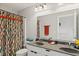 Bathroom with a dual sink vanity and an orange and green patterned shower curtain at 1037 E Woodall Ct, Martinsville, IN 46151