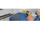 Bedroom has a treadmill, a bed with vibrant dinosaur themed pillows, and neutral carpet at 1037 E Woodall Ct, Martinsville, IN 46151