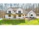 Charming white two-story home with inviting front porch and black trimmed windows on a green lawn at 1037 E Woodall Ct, Martinsville, IN 46151
