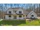 Stunning two-story modern farmhouse exterior featuring a welcoming porch and a well-manicured lawn at 1037 E Woodall Ct, Martinsville, IN 46151