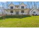 Attractive two-story home with a covered porch, set on a verdant lawn under a clear blue sky at 1037 E Woodall Ct, Martinsville, IN 46151