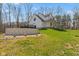 View of the home's exterior featuring a concrete wall with a deck and green grass at 1037 E Woodall Ct, Martinsville, IN 46151