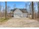 Spacious three-car garage with a gravel driveway, offering ample parking and storage at 1037 E Woodall Ct, Martinsville, IN 46151