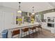 Modern kitchen with a large island, counter seating, stainless steel appliances and eye-catching backsplash at 1037 E Woodall Ct, Martinsville, IN 46151