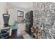 Laundry room with a stacked washer and dryer, fun wallpaper, and plenty of storage at 1037 E Woodall Ct, Martinsville, IN 46151