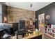 Well-appointed home office with a brick wall accent and a modern desk at 1037 E Woodall Ct, Martinsville, IN 46151