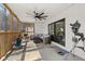 Screened-in porch with comfortable seating, overhead fan, and outdoor views at 1037 E Woodall Ct, Martinsville, IN 46151