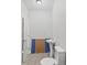 Compact powder room with a pedestal sink, toilet, and quirky decor, perfect for guests at 1037 E Woodall Ct, Martinsville, IN 46151