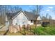 View of the home's exterior with a charming deck and backyard, showcasing the property's serene setting at 1037 E Woodall Ct, Martinsville, IN 46151