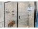 Modern walk-in shower features sleek black framing, neutral tile, and built-in shelves for toiletries at 1037 E Woodall Ct, Martinsville, IN 46151