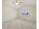 Spacious carpeted bedroom with vaulted ceiling, featuring a window view and neutral walls at 11117 Harriston Dr, Fishers, IN 46037