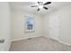 Bright and airy bedroom with neutral carpet, window, and a ceiling fan at 11117 Harriston Dr, Fishers, IN 46037
