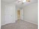 Cozy bedroom features a neutral color scheme, soft carpet, and open doorway to the upper landing at 11117 Harriston Dr, Fishers, IN 46037