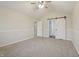 Bedroom with vaulted ceiling, ceiling fan, neutral carpet, with a doorway to hall and barn door to closet at 11117 Harriston Dr, Fishers, IN 46037