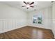 Comfortable bedroom featuring hardwood flooring, a ceiling fan, fresh paint, and a sunny window at 11117 Harriston Dr, Fishers, IN 46037