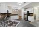 Open kitchen with stainless steel appliances, white cabinetry, and an eat-in counter at 11117 Harriston Dr, Fishers, IN 46037