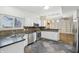 Bright kitchen with white cabinets, stainless appliances, and unique tile flooring and backsplash at 11117 Harriston Dr, Fishers, IN 46037