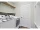 Bright laundry room with modern machines and tiled flooring at 11117 Harriston Dr, Fishers, IN 46037