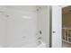 Bright white tiled shower with a bathtub, with access door to the main hallway at 11117 Harriston Dr, Fishers, IN 46037