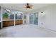 Spacious sunroom featuring paneling, a ceiling fan, and glass sliding door at 11117 Harriston Dr, Fishers, IN 46037