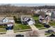 Aerial view of the street featuring a home with a large driveway and well-manicured lawn at 11124 Deer Valley Dr, Indianapolis, IN 46229